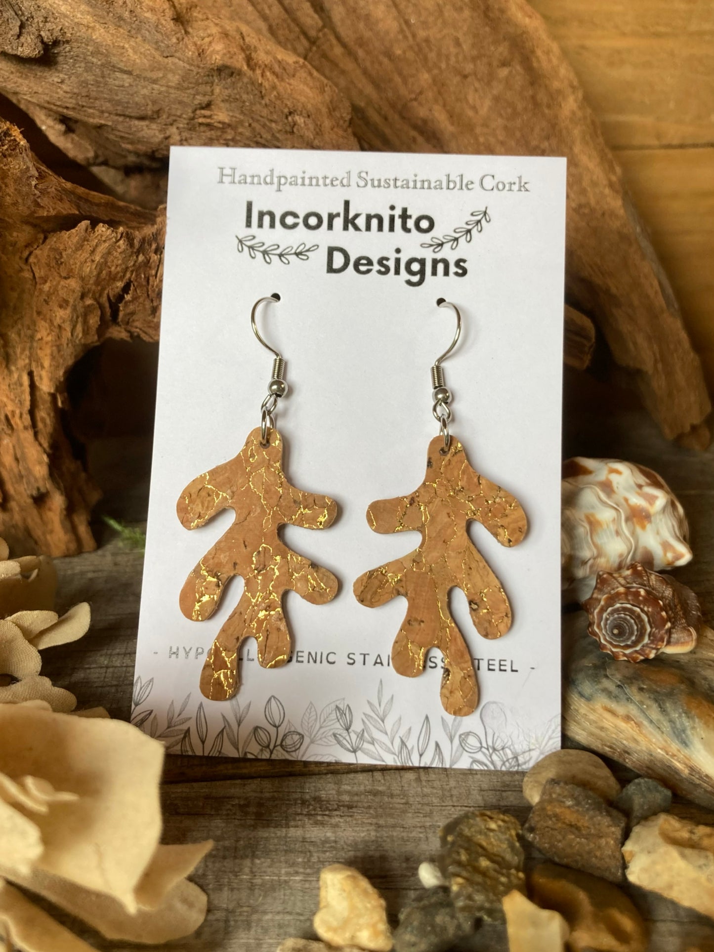 Pair of natural cork branch shaped earrings on a 'Incorknito Designs' card with natural background