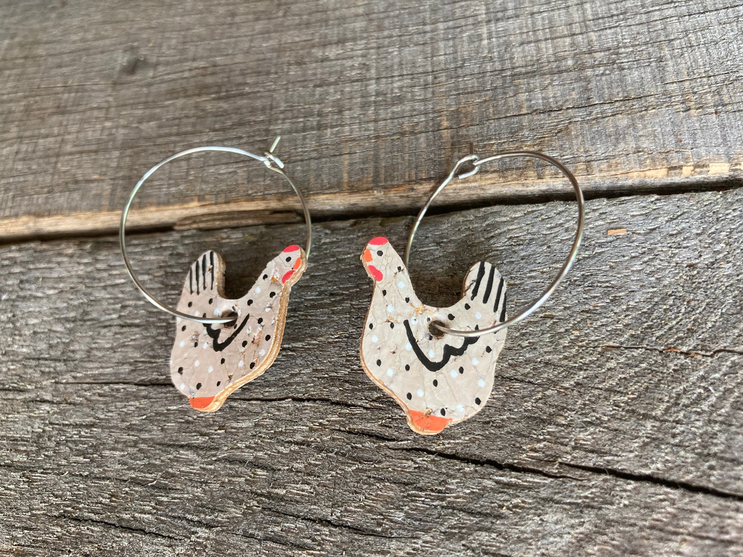 Black and white chicken cork earrings, a whimsical and eco-friendly accessory. These charming earrings feature a unique design inspired by playful chickens, adding a touch of modern flair to your style