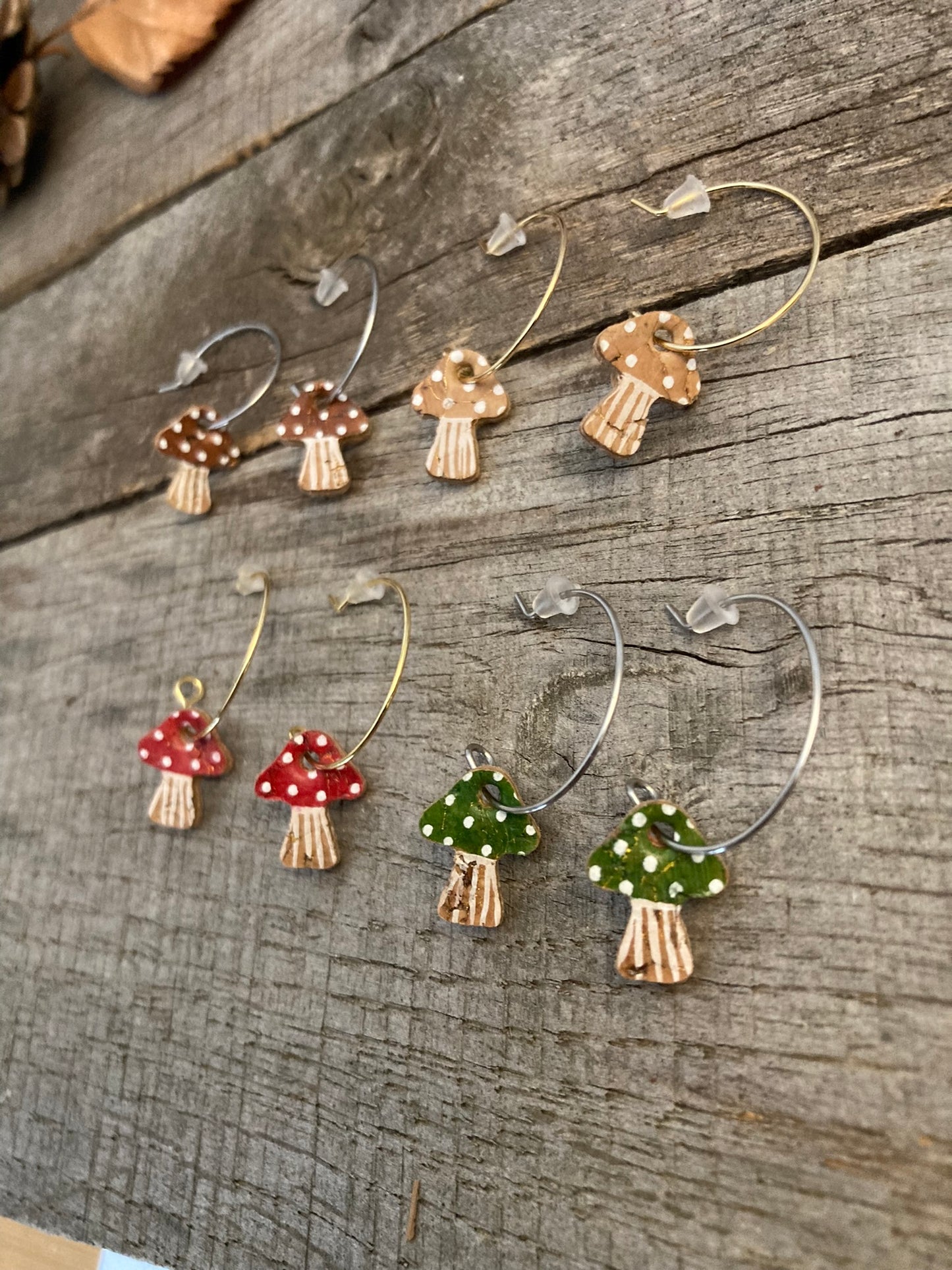 Four colourways of mini toadstool cork earrings (red, green, brown and beige)