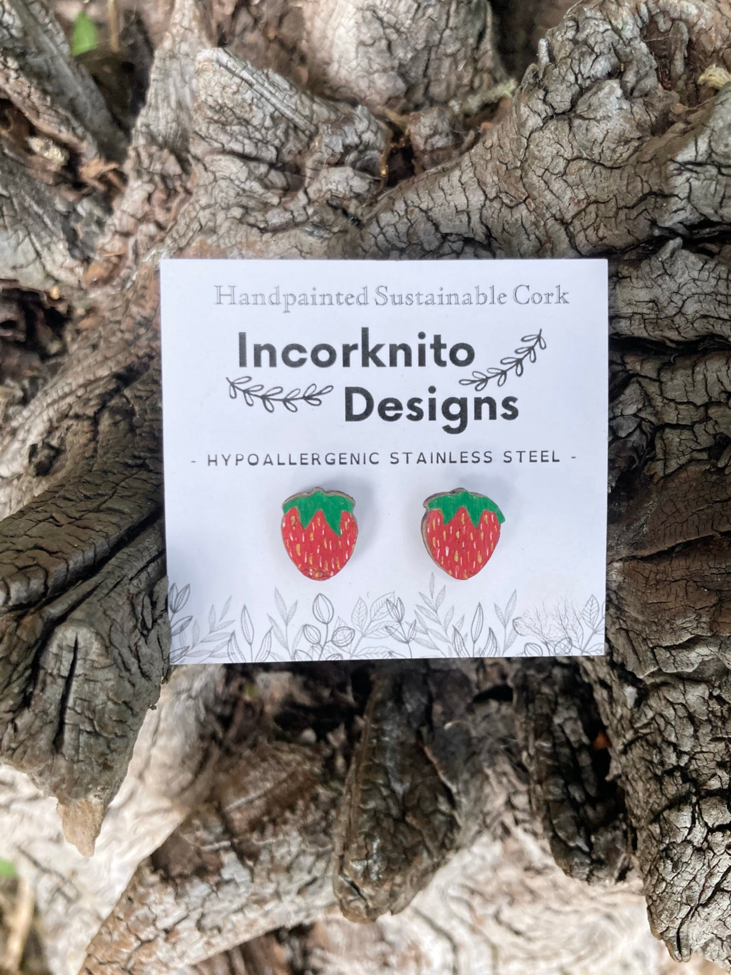 Strawberry cork stud earrings on an Incorknito Designs branded card with cork background