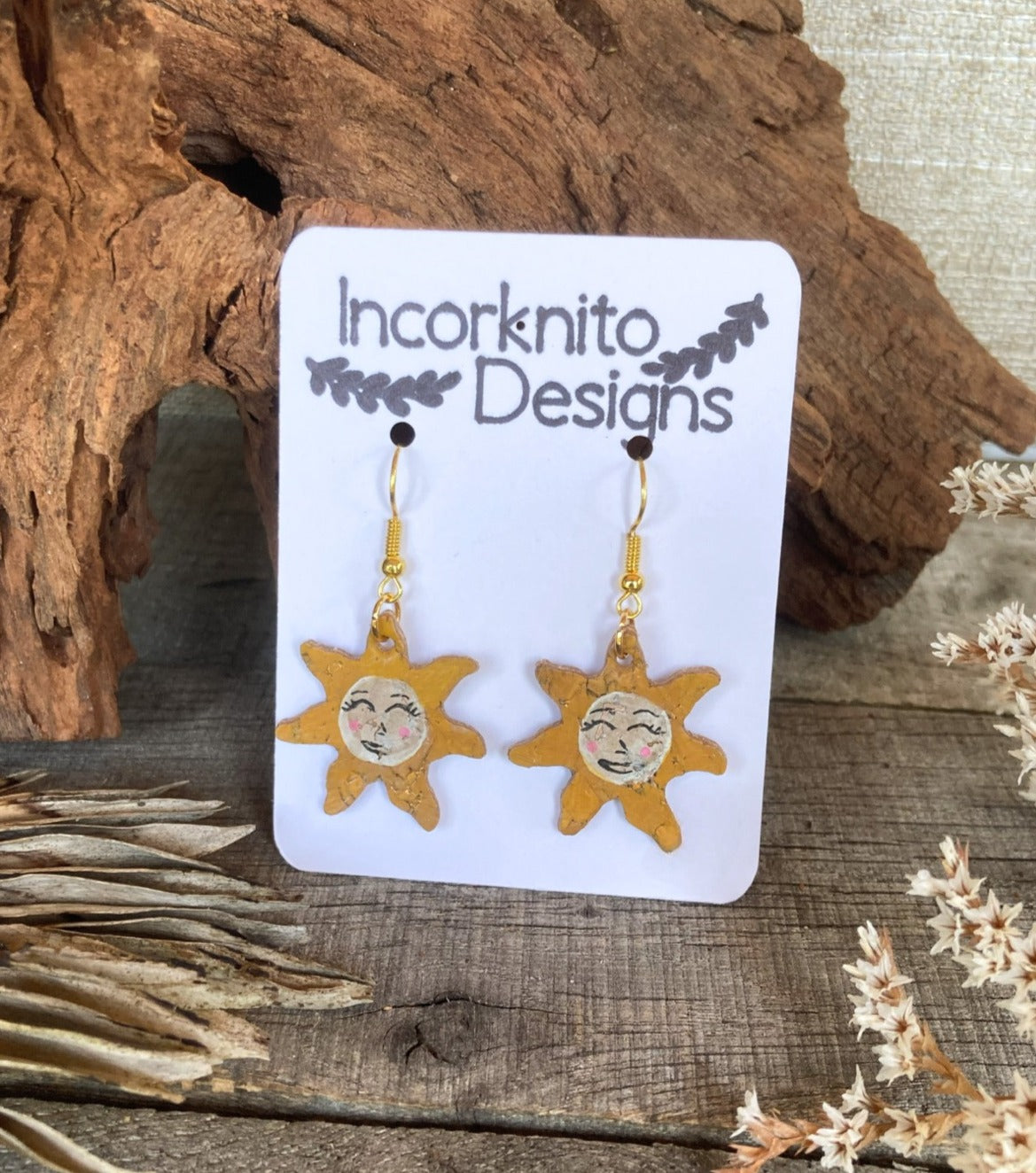 Sun-shaped cork earrings with a delightful smile, a whimsical and sustainable accessory.