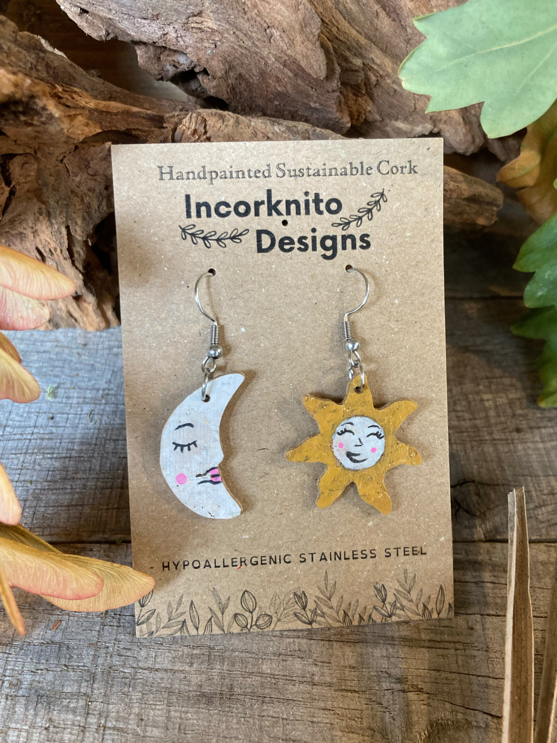 Sun and moon cork earrings on a card with 'Incorknito Designs' branding.