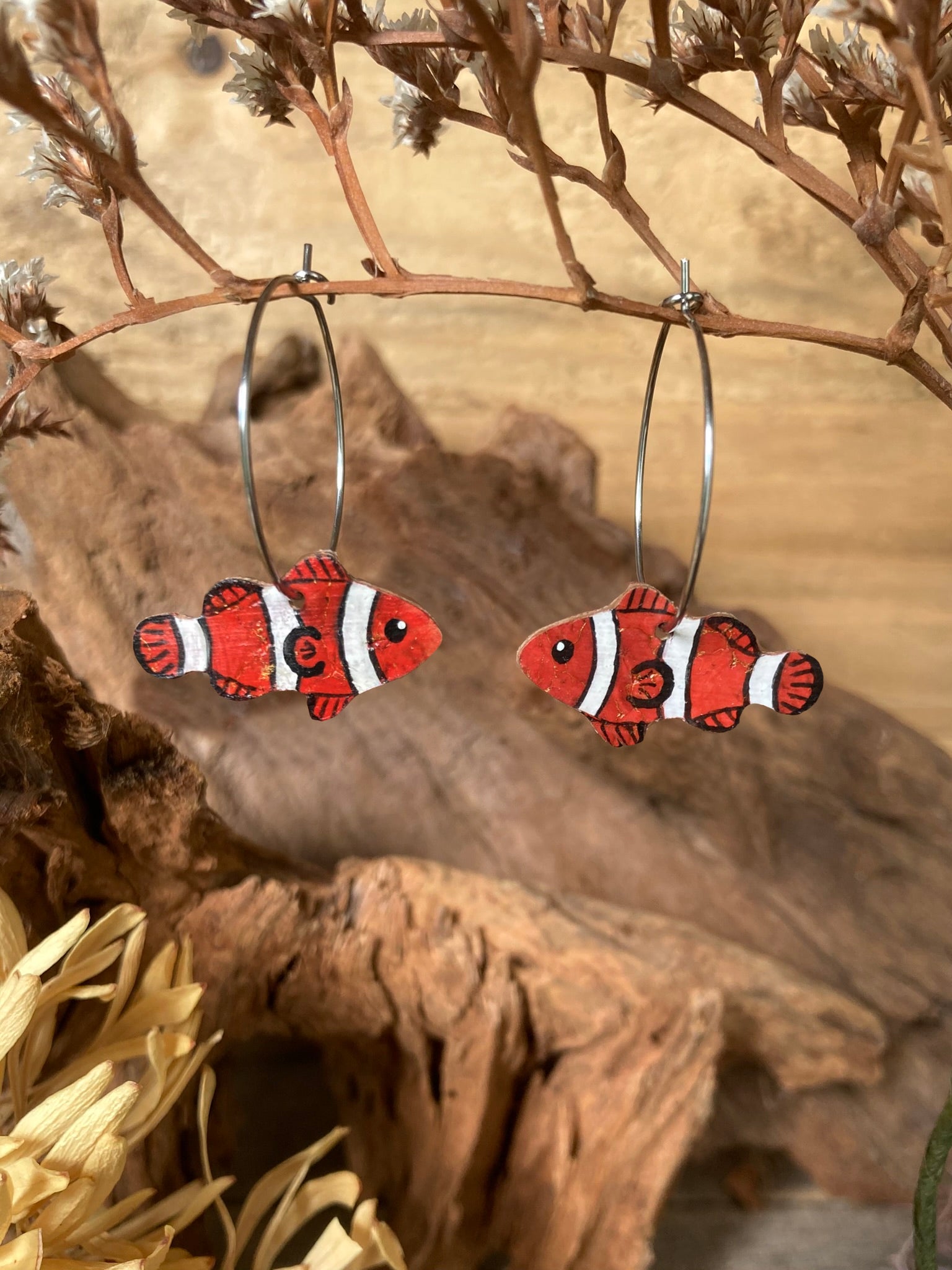 Pair of clownfish earrings on a natural background