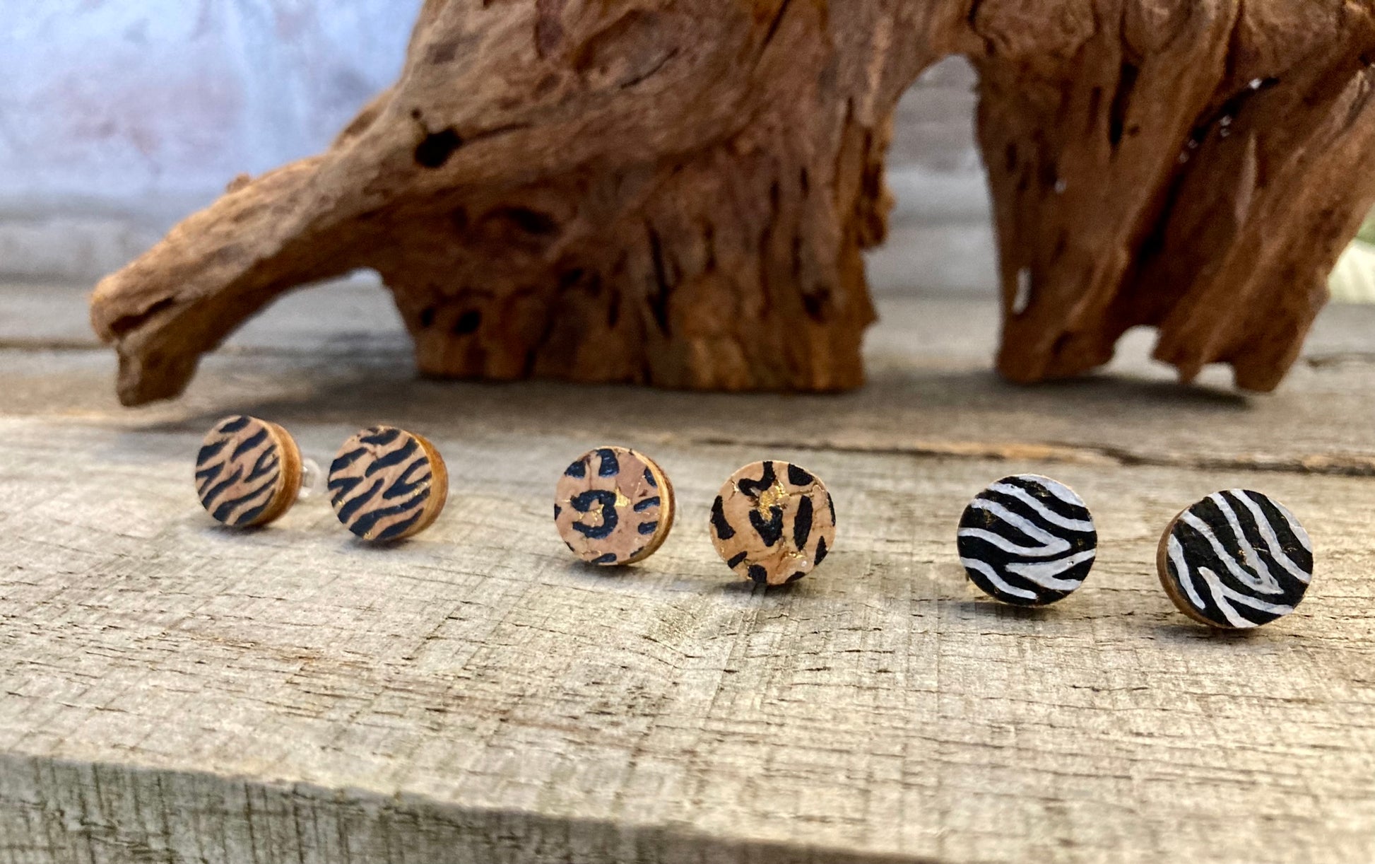 Three pairs of animal print studs - one leopard, one tiger and one zebra print. Crafted from sustainable cork and plywood