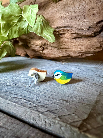 Front and back view of a blue tit cork stud earring showing the natural wood reverse and hypoallergenic stainless steel post