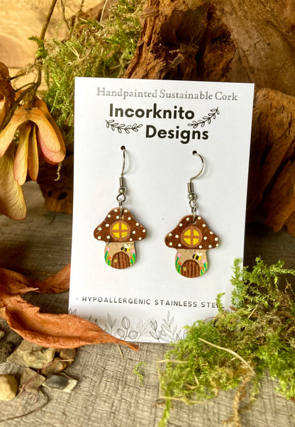 Brown Fairy House Toadstool Earrings on an Incorknito Designs branded card with natural woodland background