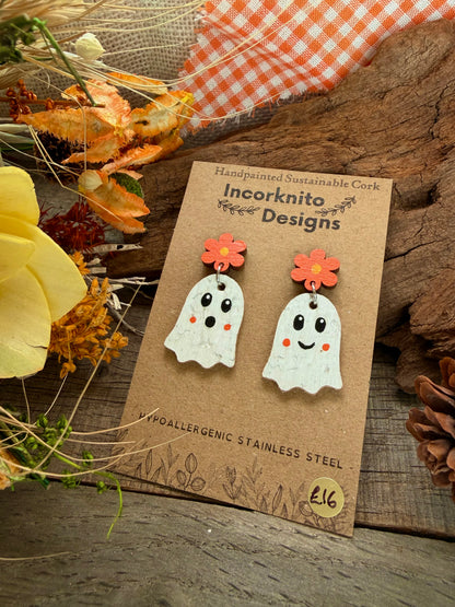 Cork ghost earrings with orange flower tops and matching orange cheeks, displayed on a kraft card
