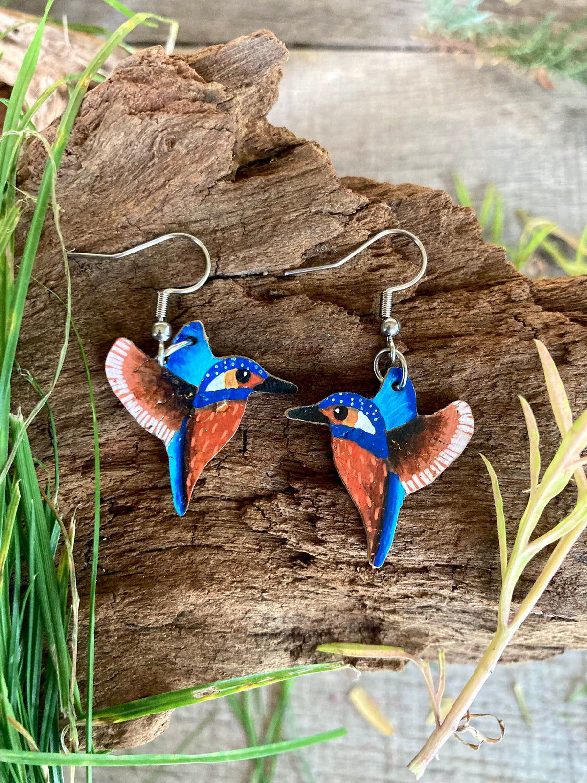 Handpainted kingfisher cork earrings on silver hooks on driftwood with grass — British wildlife jewellery handmade in Suffolk UK