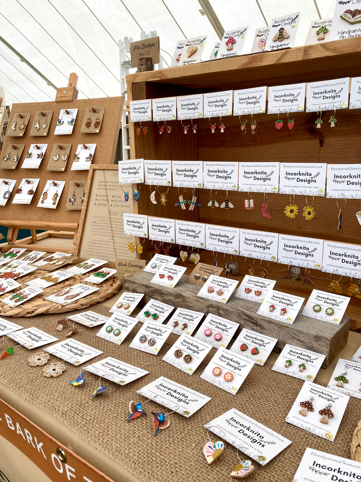 Market display of the brands work showing a range of hoop earrings, stud earrings and hook earrings laid out on a table