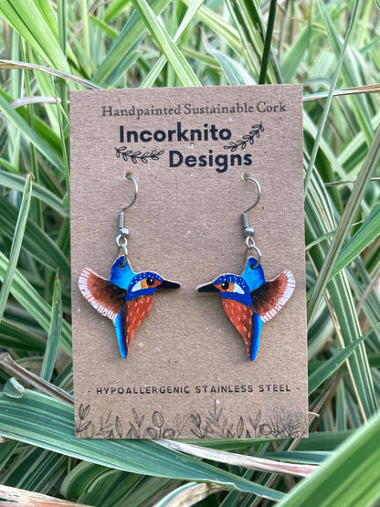 Kingfisher cork earrings on Incorknito Designs branded card surrounded by green reeds — handpainted sustainable cork bird earrings
