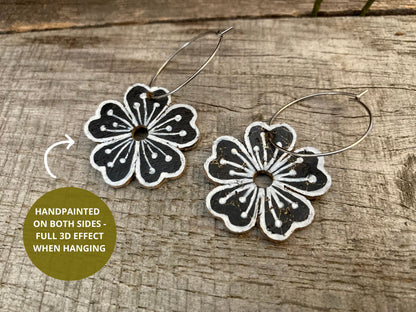 Large flower cork hoop earrings handpainted on both sides — showing full 3D effect when hanging, with white pollen detail on black cork