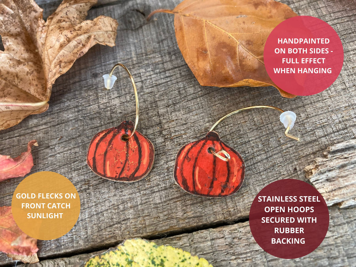  Pumpkin cork earring features: handpainted on both sides, gold flecks that catch sunlight, and stainless steel open hoops secured with rubber backs.