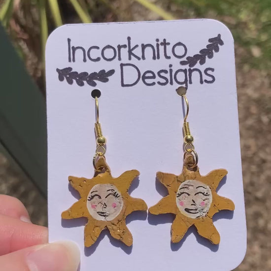 Video of smiling sun earrings outside