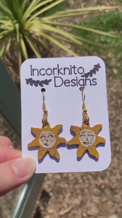 Video of smiling sun earrings outside