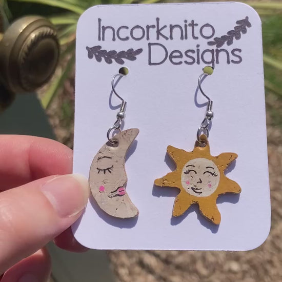 Video depicting our smiley sun and moon earrings in the sunshine. Gold flecks glimmering the sunlight