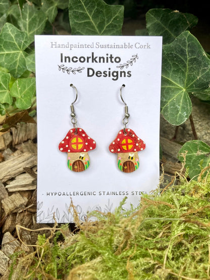 Red Fairy House Toadstool Earrings on hooks — handpainted cork showing window, door and bee detail, on Incorknito Designs card with ivy background