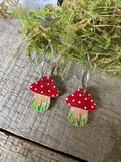 Red Fairy House Toadstool Earrings on large hoops — reverse side showing handpainted cork toadstool with grass detail