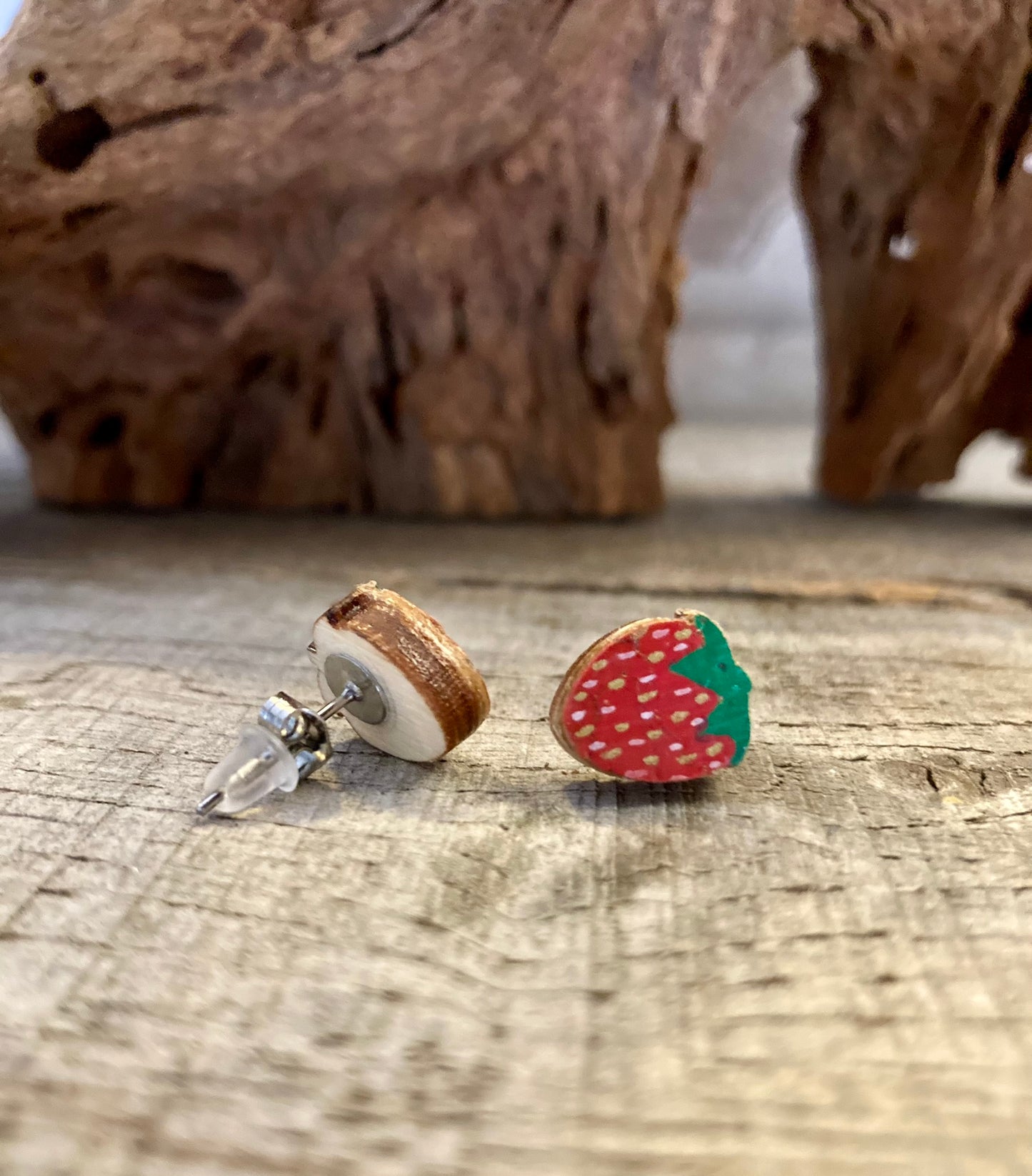 Strawberry cork stud earring showing front painted face and FSC wood reverse with stainless steel butterfly and silicone posts